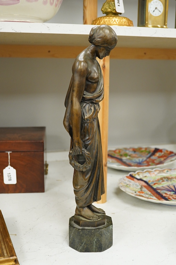 An early 20th century bronze figure of a classical maiden holding a laurel wreath, 46cm high. Condition - good